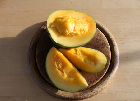 Cut mango on board in sunshine.の写真素材