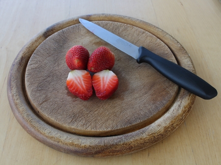 Cut Strawberry on board with knife.の写真素材