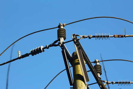 connectors and insulators atop a transmission pole.