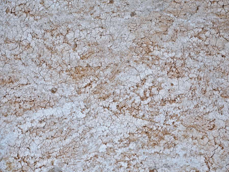 Old cement floor that has cracked due to a very long age.