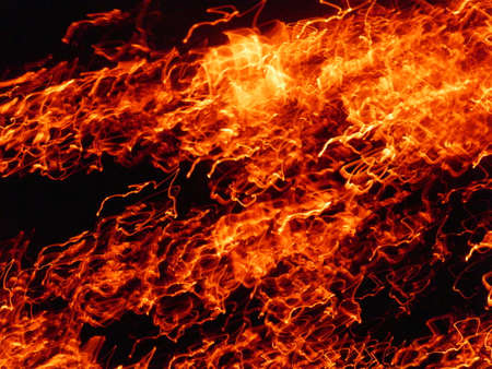Fire flames with sparks on a black background.By shooting at high speed.
