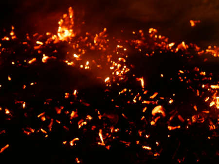 Fire flames with sparks on a black background.By shooting at high speed.