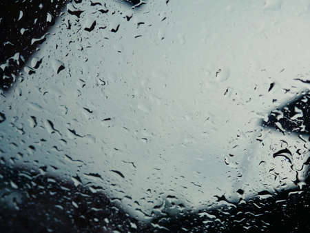 Rain drops on the car glass when it rains.の写真素材
