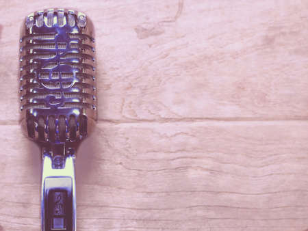 Vintage style classic microphone placed on an old wood.の写真素材