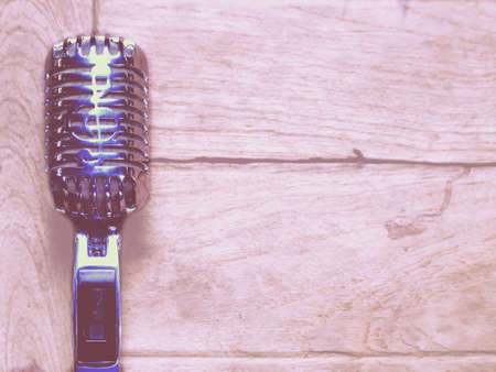 Vintage style classic microphone placed on an old wood.の写真素材