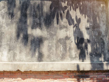 The old cement wall was weathered, the surface was scratched, the surface was scratched and damaged....
