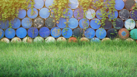 Old oil tanks are stacked on top of each other for recycling.
