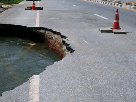 Natural flood disasters have damaged road surfaces and damaged road surfaces. cause traffic congestionの写真素材