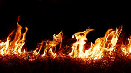 Haystack fires at night in arid areas The ash erupted and the wind was very dangerous. ashes red as...