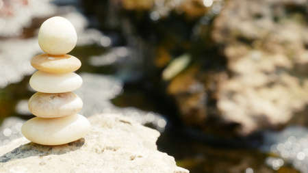 The Balance Stones are stacked as pyramids in a soft natural bokeh background, representing the calm...