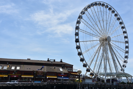 SEATTLE, WA - JUL 15: View of The Seattle Great Wheel at Pier 57 in Seattle, Washington, on July 15, 2019. With an overall height of 175 feet, it was the tallest Ferris wheel on the West Coast of USA.のeditorial素材