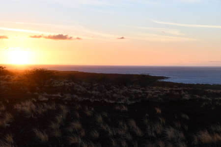 Sunset over the Pacific Ocean in Kailua Kona in Hawaiiの写真素材
