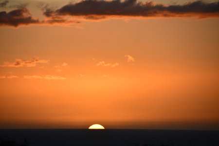 Sunset over the Pacific Ocean in Kailua Kona in Hawaiiの写真素材