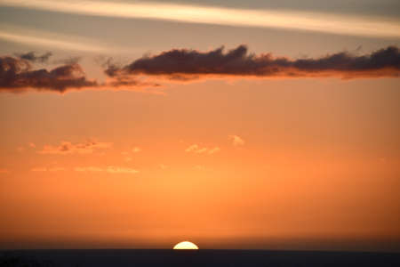 Sunset over the Pacific Ocean in Kailua Kona in Hawaiiの写真素材
