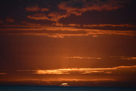 Sunset over the Pacific Ocean in Kailua Kona in Hawaiiの写真素材