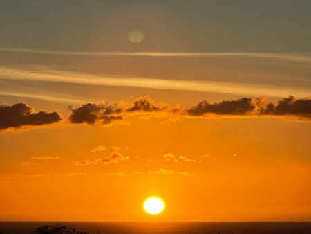 Sunset over the Pacific Ocean in Kailua Kona in Hawaiiの写真素材