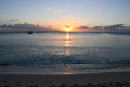 Sunset view from the Seven Mile Beach on Grand Cayman in the Cayman Islandsの写真素材