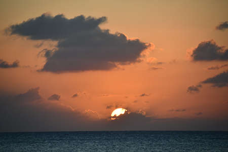 Sunset view from the Seven Mile Beach on Grand Cayman in the Cayman Islandsの写真素材