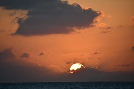 Sunset view from the Seven Mile Beach on Grand Cayman in the Cayman Islandsの写真素材