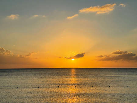 Sunset view from the Seven Mile Beach on Grand Cayman in the Cayman Islandsの写真素材