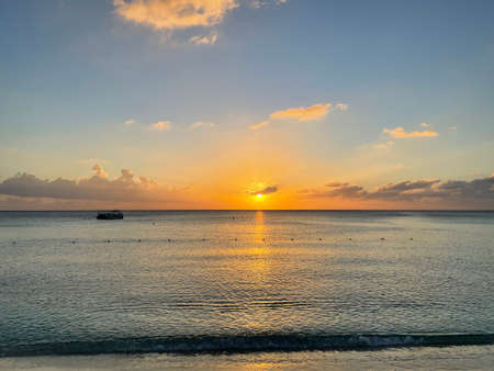 Sunset view from the Seven Mile Beach on Grand Cayman in the Cayman Islandsの写真素材