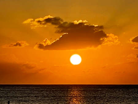 Sunset view from the Seven Mile Beach on Grand Cayman in the Cayman Islandsの写真素材