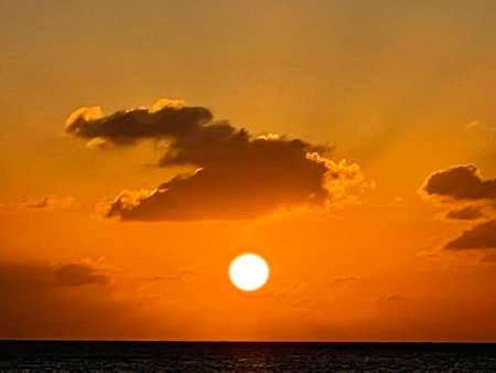 Sunset view from the Seven Mile Beach on Grand Cayman in the Cayman Islandsの写真素材