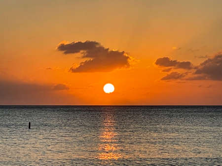 Sunset view from the Seven Mile Beach on Grand Cayman in the Cayman Islandsの写真素材