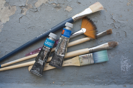 MILAN, ITALY, AUGUST 17, 2015: Brushes and oil color tubes, on grunge backgroundのeditorial素材