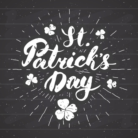 Happy St Patrick's Day Vintage greeting card Hand lettering, Irish holiday grunge textured retro design vector illustration on chalkboard background in black backgroundのイラスト素材