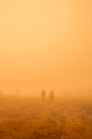 Poas Volcano National Park, Alajuela, Costa Rica. Couple of young hikers and adventurers gathered in the arid field of stone and earthの写真素材
