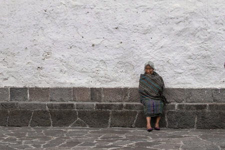 Indigenous older adult woman sitting near a square in the middle of a weekend afternoon. Atitlan lake, Guatemala.のeditorial素材