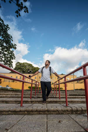 adult tourist walking down the steps of a public park in the center of the city of San Jose in Costa...