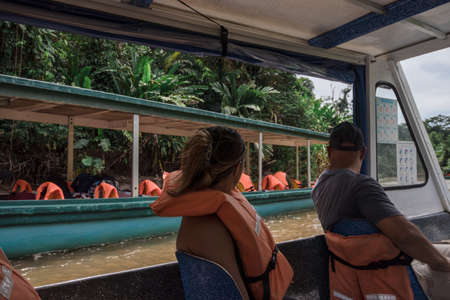 tourist couple sailing on the river surrounded by natureの写真素材