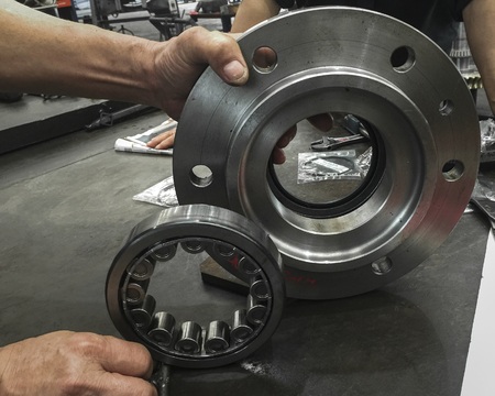 Industrial bearings part. With the mechanics hands.の写真素材