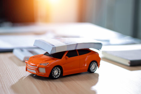 Car model with book on the desk. Education and learning concept.の写真素材