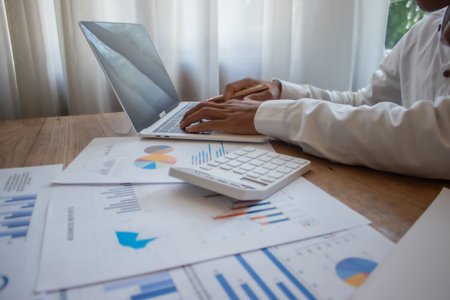 Businessman analyzing investment charts with laptop. Accounting,investment concept.の写真素材