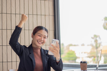 Beautiful business woman smiling happily working at modern work station and using laptop.