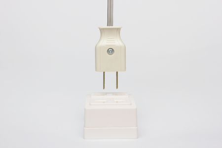AC power plug with electrical cable on white background.