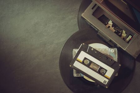 Cassette player and platter record on cement floor. Top view and copy space for text. Concept of vintage of music.の写真素材