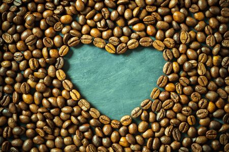 Coffee bean in heart shape on wooden table. Concept i love coffee.の写真素材