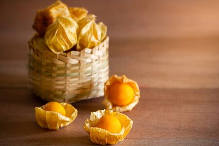 Cape gooseberry in bamboo basket. Concept of health care or herb. Closeup and copy space for text.の写真素材