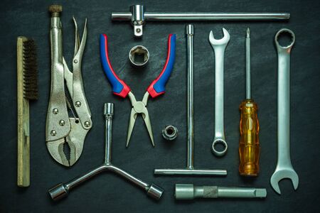 Set of many hand tools on cement floor. Top view of craftsman tool on black background. Concept of technician or engineer.の写真素材