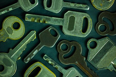 Close up much different variety of vintage keys placed like scatter on black wooden table background. Idea for keys to solving business problems to success to success. Concept for security or privacy.の写真素材