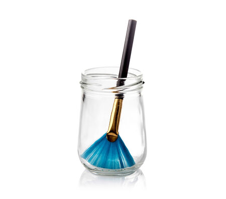 Paintbrush in glass bottles isolated on a whiteの写真素材