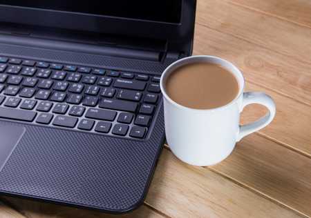 Coffee cup with the computer の写真素材