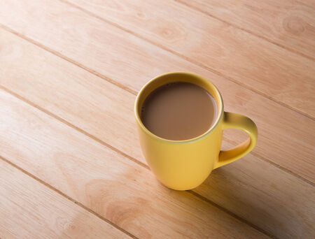 Coffee cup placed on a wooden floor の写真素材