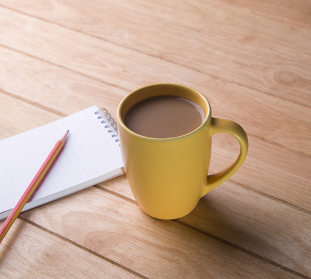 Coffee cup with notebooks and pencils の写真素材