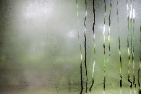 Water drops on steamed up window の写真素材