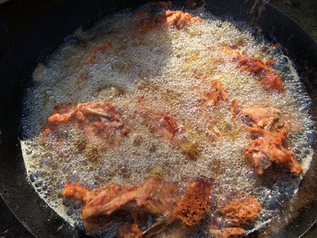 Chicken grilled in oil fire.